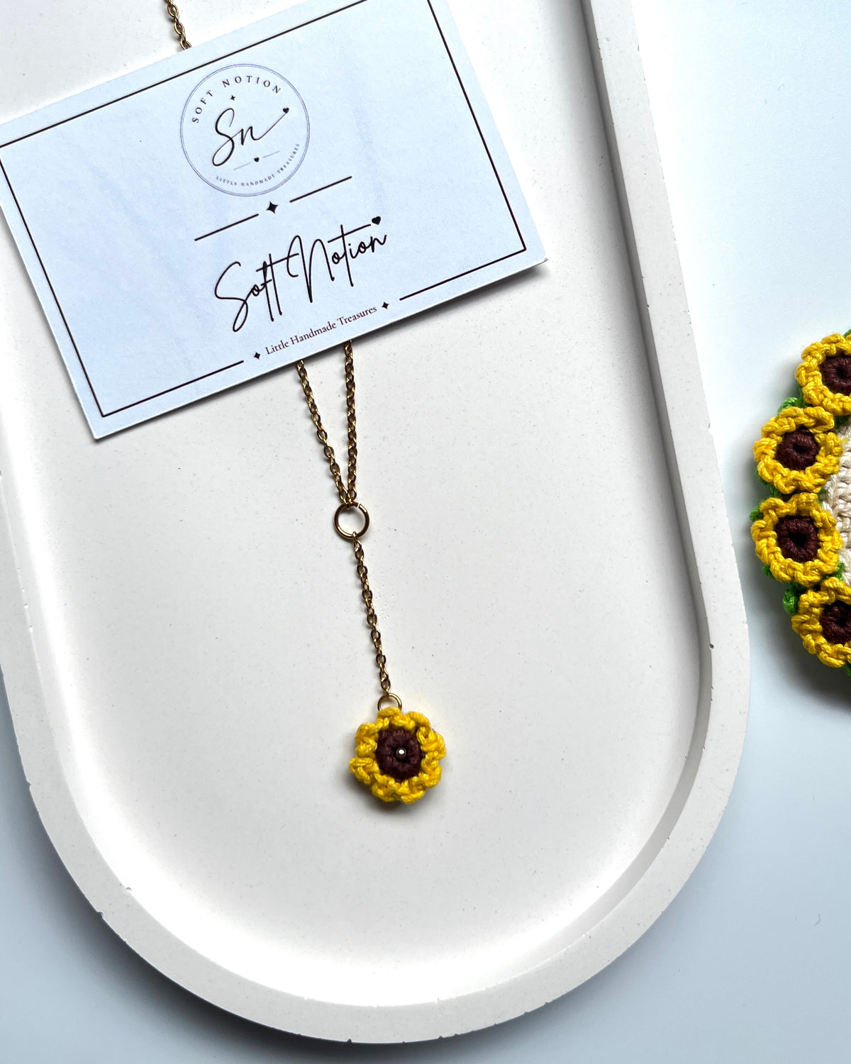 Sunshine Necklace with miniature crochet sunflower charm on a delicate gold-toned chain