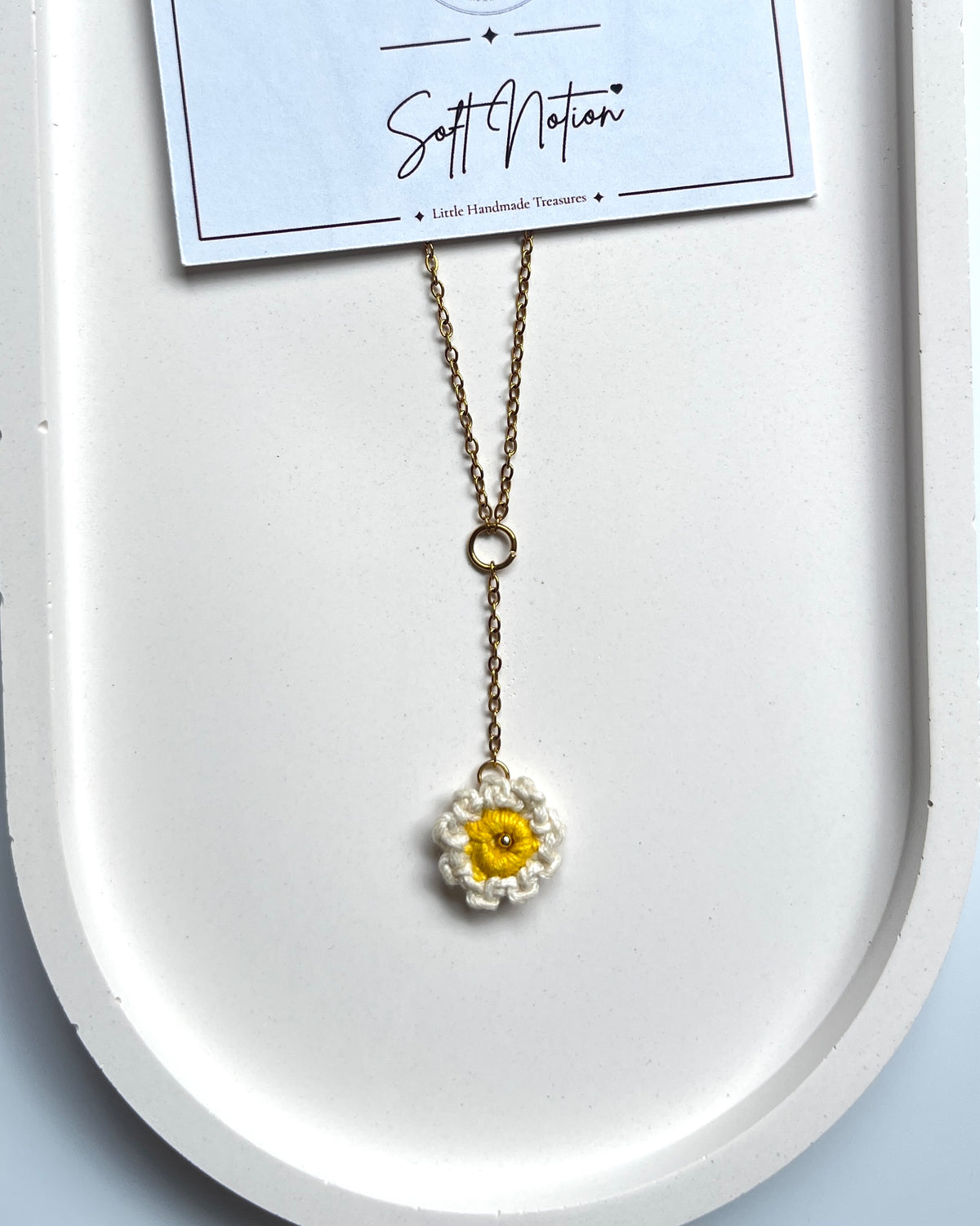 Daydream Necklace with white and yellow crochet daisy charm and delicate gold-toned chain