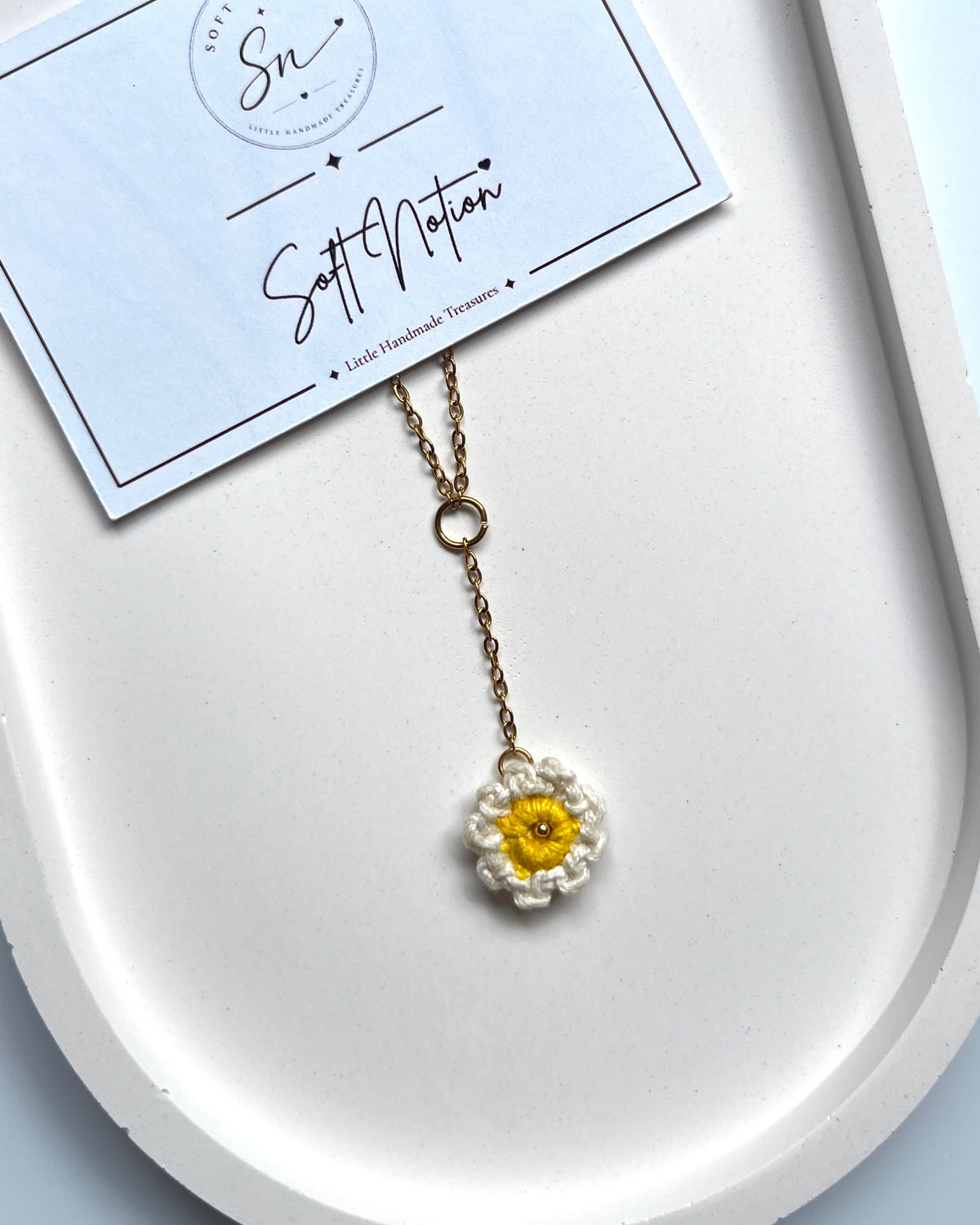 Close-up of Daydream Necklace with miniature crochet daisy charm and centre drop chain