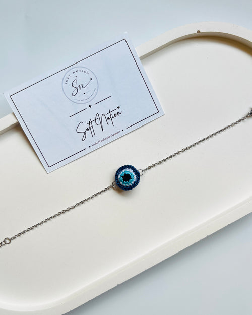 Evil eye bracelet with miniature blue crochet charm and delicate silver-toned chain