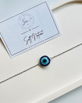 Handmade crochet evil eye bracelet with blue miniature 3D charm and silver-toned chain