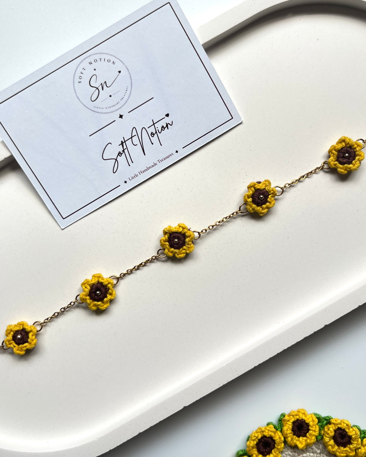 Sunshine Anklet with five miniature crochet sunflower charms arranged along a delicate gold-toned chain