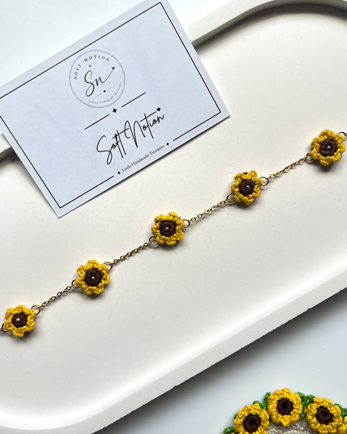 Sunshine Anklet with five miniature crochet sunflower charms arranged along a delicate gold-toned chain