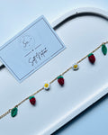 Strawberry Muse Bracelet with hand-crocheted strawberries, daisies and leaves on a gold-toned chain